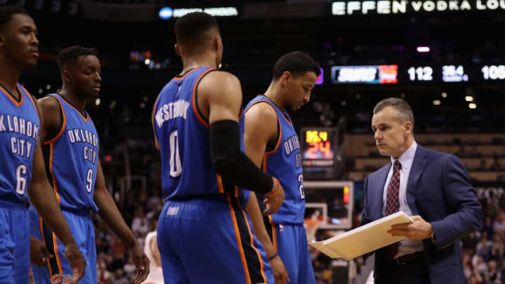 PHOENIX, AZ - MARCH 03: Head coach Billy Donovan of the Oklahoma City Thunder talks with Andre Roberson