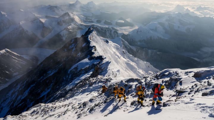 Team members climb up a slope during the expedition to find Sandy Irvine's remains on Mount Everest.