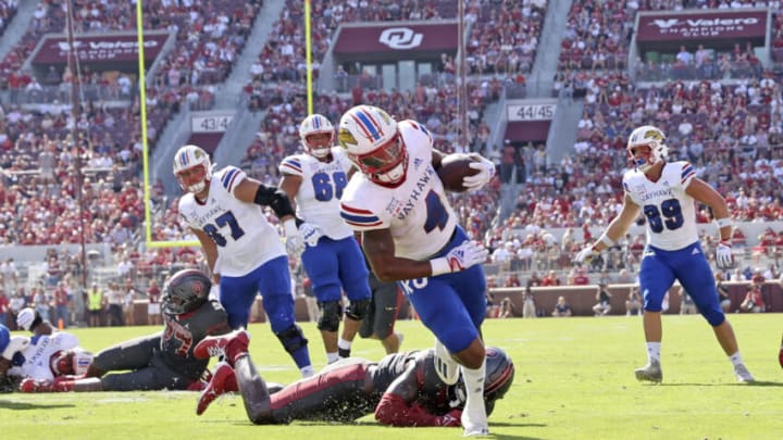 Oct 15, 2022; Norman, Oklahoma, USA; Kansas Jayhawks running back Devin Neal (4) scores a touchdown during the first half against the Oklahoma Sooners at Gaylord Family-Oklahoma Memorial Stadium. Mandatory Credit: Kevin Jairaj-USA TODAY Sports