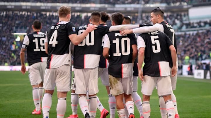 Juventus' Portuguese forward Cristiano Ronaldo (R) celebrates with teammates after scoring his second penalty, and his 50th goal with Juventus, during the Italian Serie A football match Juventus vs Fiorentina on February 2, 2020 at the Juventus Allianz stadium in Turin. (Photo by Marco BERTORELLO / AFP) (Photo by MARCO BERTORELLO/AFP via Getty Images)