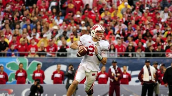 Jan 1, 2014; Orlando, FL, USA; Wisconsin Badgers quarterback Joel Stave (2) drops back to pass as the South Carolina beats Wisconsin 34-24 in the Capital One Bowl at Florida Citrus Bowl. Mandatory Credit: David Manning-USA TODAY Sports