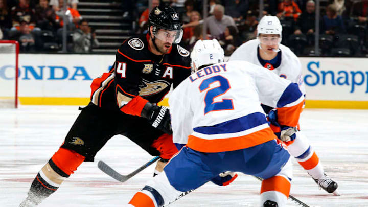 ANAHEIM, CA - OCTOBER 17: Adam Henrique #14 of the Anaheim Ducks skates with the puck against Nick Leddy #2 of the New York Islanders during the game on October 17, 2018 at Honda Center in Anaheim, California. (Photo by Debora Robinson/NHLI via Getty Images)