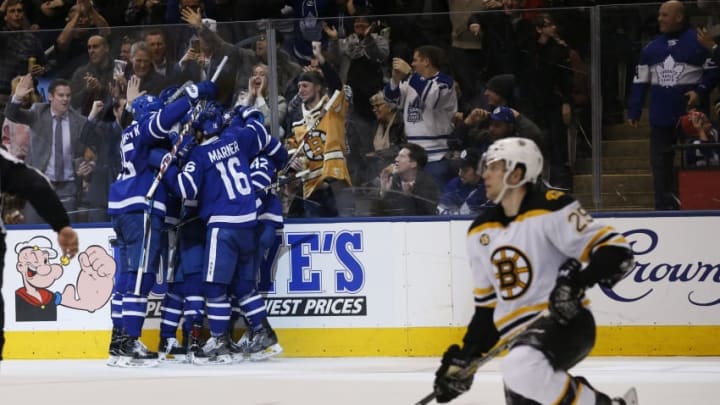 TORONTO, ON - MARCH 20: Leafs celebrate the 2nd goal, by Tyler Bozak as Boston Bruins defenseman Brandon Carlo (25) kneels. Toronto Maple Leafs VS Boston Bruins during 3rd period action in NHL regular season play at the Air Canada Centre. Leafs won 4-2. Toronto Star/Rick Madonik (Rick Madonik/Toronto Star via Getty Images)