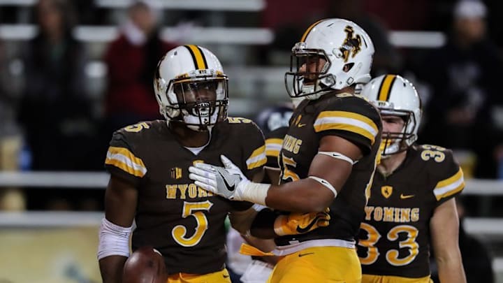 Nov 5, 2016; Laramie, WY, USA; Wyoming Cowboys running back Brian Hill (5) scores a touchdown against the Utah State Aggies during the first quarter at War Memorial Stadium. Mandatory Credit: Troy Babbitt-USA TODAY Sports
