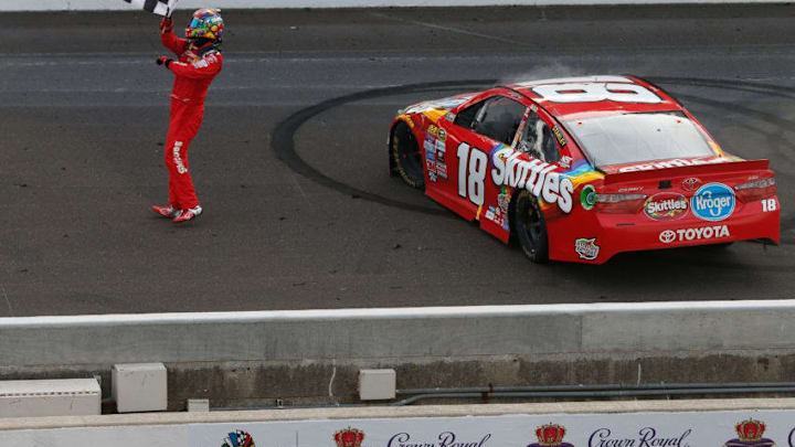 INDIANAPOLIS, IN - JULY 24: Kyle Busch, driver of the #18 Skittles Toyota, celebrates after winning the NASCAR Sprint Cup Series Crown Royal Presents the Combat Wounded Coalition 400 at Indianapolis Motor Speedway on July 24, 2016 in Indianapolis, Indiana. (Photo by Brian Lawdermilk/Getty Images)