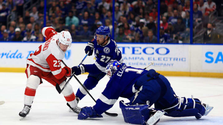 TAMPA, FLORIDA - MARCH 04: Brian Elliott #1 of the Tampa Bay Lightning stops a shot from Lucas Raymond #23 of the Detroit Red Wings in the first period during a game at Amalie Arena on March 04, 2022 in Tampa, Florida. (Photo by Mike Ehrmann/Getty Images)
