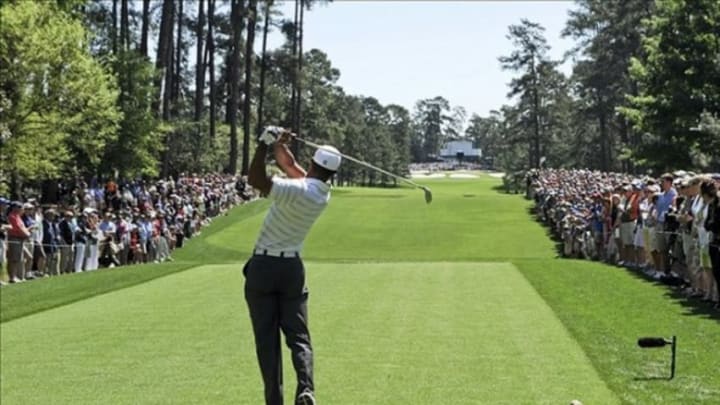 Apr 7, 2012; Augusta, GA, USA; Tiger Woods hits his tee shot on the 7th hole during the third round of the 2012 The Masters golf tournament at Augusta National Golf Club. Mandatory Credit: Michael Madrid-USA TODAY Sports