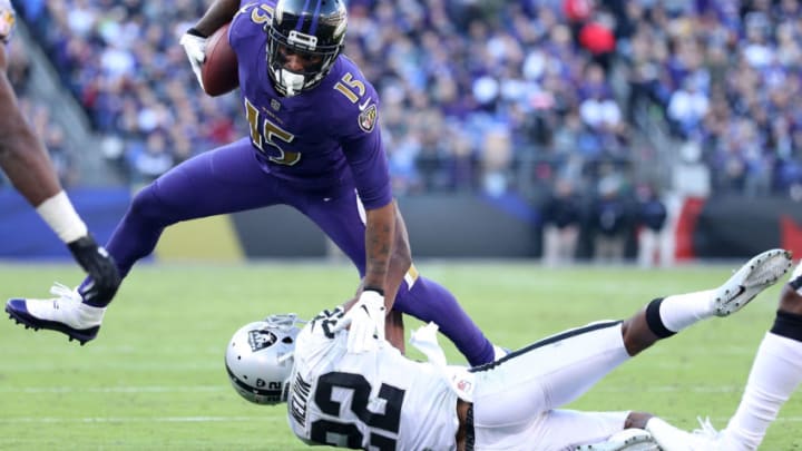BALTIMORE, MARYLAND - NOVEMBER 25: Wide Receiver Michael Crabtree #15 of the Baltimore Ravens is tackled after a catch by cornerback Rashaan Melvin #22 of the Oakland Raiders in the third quarter at M&T Bank Stadium on November 25, 2018 in Baltimore, Maryland. (Photo by Patrick Smith/Getty Images)