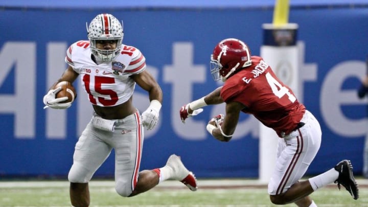 Jan 1, 2015; New Orleans, LA, USA; Ohio State Buckeyes running back Ezekiel Elliott (15) runs past Alabama Crimson Tide defensive back Eddie Jackson (4) during the first quarter of the 2015 Sugar Bowl at Mercedes-Benz Superdome. Mandatory Credit: Derick E. Hingle-USA TODAY Sports