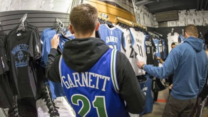 Feb 25, 2015; Minneapolis, MN, USA; Minnesota Timberwolves fan Collins Jones looks at buying Minnesota Timberwolves Kevin Garnett jersey before a game between the Minnesota Timberwolves and Washington Wizards at Target Center. Mandatory Credit: Jesse Johnson-USA TODAY Sports
