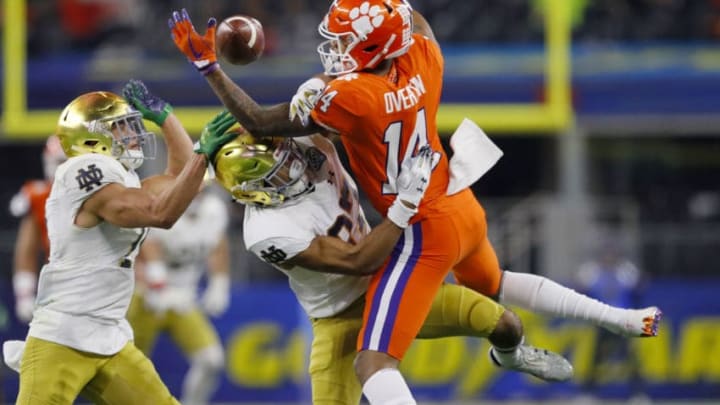 ARLINGTON, TEXAS - DECEMBER 29: Diondre Overton #14 of the Clemson Tigers competes for the ball with Julian Love #27 of the Notre Dame Fighting Irish in the second half during the College Football Playoff Semifinal Goodyear Cotton Bowl Classic at AT&T Stadium on December 29, 2018 in Arlington, Texas. (Photo by Kevin C. Cox/Getty Images)