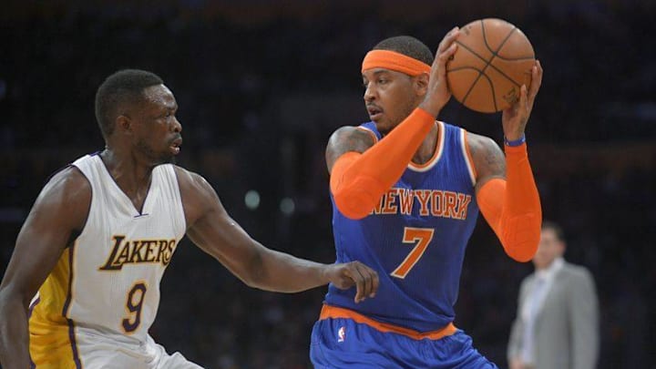 December 11, 2016; Los Angeles, CA, USA; New York Knicks forward Carmelo Anthony (7) controls the ball against the defense of Los Angeles Lakers forward Luol Deng (9) during the first half at Staples Center. Mandatory Credit: Gary A. Vasquez-USA TODAY Sports