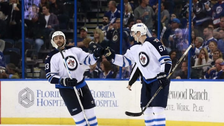 Feb 18, 2016; Tampa, FL, USA; Winnipeg Jets defenseman Tyler Myers (57) is congratulated by defenseman Dustin Byfuglien (33) after he scored a goal against the Tampa Bay Lightning during the second period at Amalie Arena. Mandatory Credit: Kim Klement-USA TODAY Sports