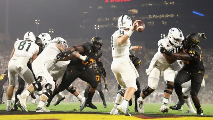 TEMPE, AZ - SEPTEMBER 08: Quarterback Brian Lewerke #14 of the Michigan State Spartans drops back to pass under pressure from linebacker Darien Butler #37 of the Arizona State Sun Devils during the first half of the college football game against the Arizona State Sun Devils at Sun Devil Stadium on September 8, 2018 in Tempe, Arizona. (Photo by Christian Petersen/Getty Images)