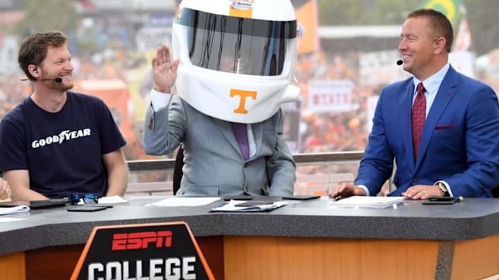 Sep 10, 2016; Bristol, TN, USA; ESPN analyst Lee Corso puts on a Tennessee Volunteers racing helmet as he makes his game pick with NASCAR Sprint Cup driver Dale Earnhardt Jr. and ESPN commentator Kirk Herbstreit prior to the Battle at Bristol football game between the Virginia Tech Holies and Tennessee Volunteers at Bristol Motor Speedway. Mandatory Credit: Christopher Hanewinckel-USA TODAY Sports