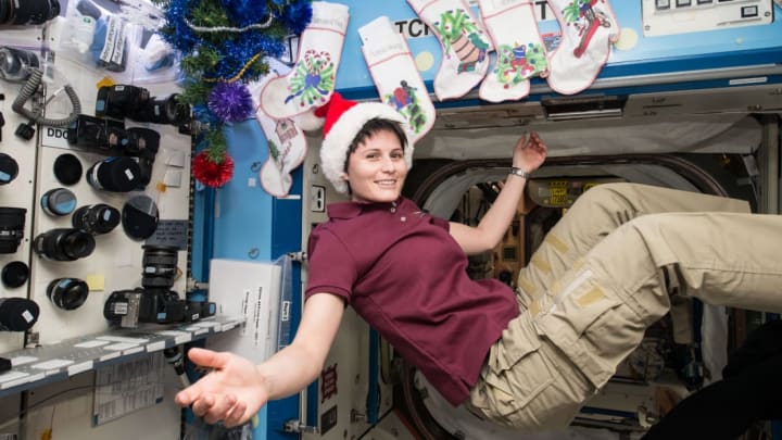 Expedition 42 Flight Engineer Samantha Cristoforetti of the European Space Agency relaxes on board the International Space Station on December 25, 2014.