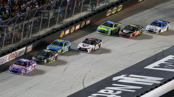 Aug 20, 2016; Bristol, TN, USA; NASCAR Sprint Cup Series driver Kyle Larson (42) and driver Kurt Busch (41) lead a pack of cars during the Bass Pro Shops NRA Night Race at Bristol Motor Speedway. Mandatory Credit: Randy Sartin-USA TODAY Sports