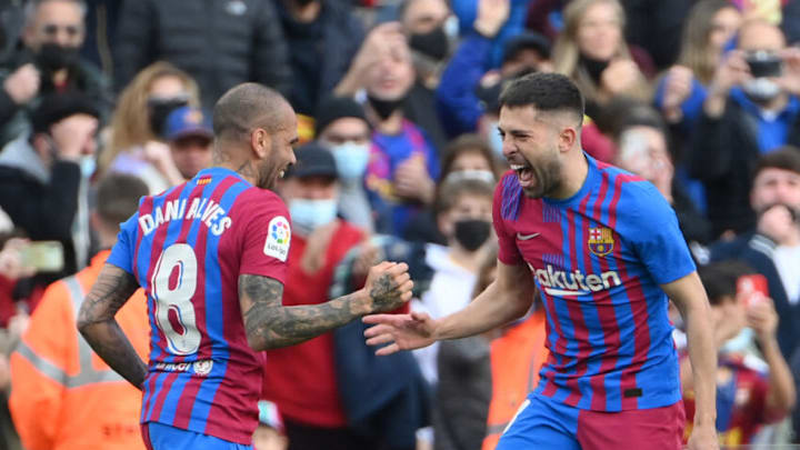 Barcelona's Jordi Alba (R) celebrates with Dani Alves after scoring a goal during the Spanish league football match between FC Barcelona and Club Atletico de Madrid at the Camp Nou stadium in Barcelona on February 6, 2022. (Photo by LLUIS GENE/AFP via Getty Images)