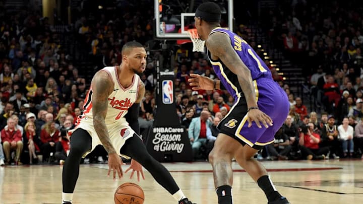 PORTLAND, OREGON - DECEMBER 06: Damian Lillard #0 of the Portland Trail Blazers dribbles the ball on Kentavious Caldwell-Pope #1 of the Los Angeles Lakers during the first half of the game at Moda Center on December 06, 2019 in Portland, Oregon. NOTE TO USER: User expressly acknowledges and agrees that, by downloading and or using this photograph, User is consenting to the terms and conditions of the Getty Images License Agreement. (Photo by Steve Dykes/Getty Images) PORTLAND, OREGON - DECEMBER 06: Damian Lillard #0 of the Portland Trail Blazers dribbles the ball on Kentavious Caldwell-Pope #1 of the Los Angeles Lakers during the first half of the game at Moda Center on December 06, 2019 in Portland, Oregon. NOTE TO USER: User expressly acknowledges and agrees that, by downloading and or using this photograph, User is consenting to the terms and conditions of the Getty Images License Agreement. (Photo by Steve Dykes/Getty Images)