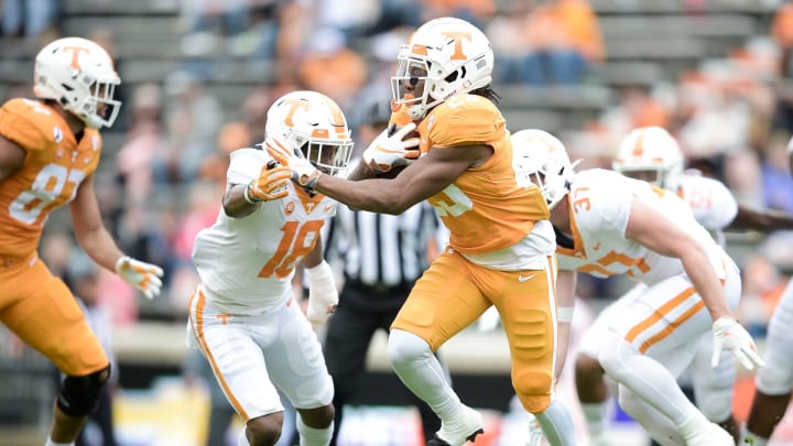 Tennessee running back Jaylen Wright (23) runs with the ball as Tennessee defensive back Doneiko Slaughter (18) defends at the Orange & White spring game at Neyland Stadium in Knoxville, Tenn. on Saturday, April 24, 2021.Kns Vols Spring Game