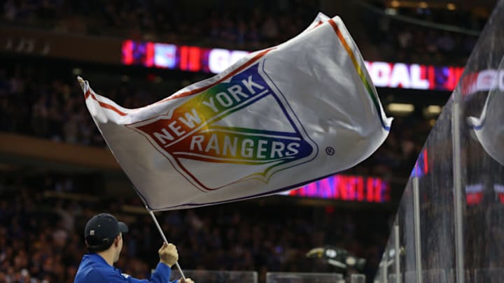 Mar 5, 2020; New York, New York, USA; New York Rangers fans and blue crew celebrate a goal against the Washington Capitals with rainbow flags for pride night during the second period at Madison Square Garden. Mandatory Credit: Brad Penner-USA TODAY Sports
