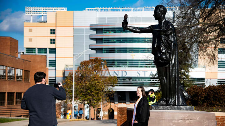 New Tennessee nursing graduate Amanda Widick poses for photos in front of the Torchbearer before the Tennessee and Florida college football game at the University of Tennessee in Knoxville, Tenn., on Saturday, Dec. 5, 2020.Pregame Tennessee Vs Florida 2020 111355