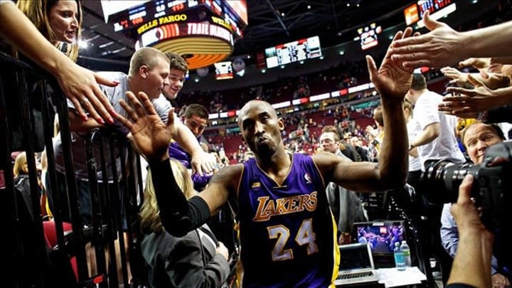 Apr 10, 2013; Portland, OR, USA; Los Angeles Lakers shooting guard Kobe Bryant (24) high fives fans after scoring 47 points against the Portland Trail Blazers at the Rose Garden. Mandatory Credit: Craig Mitchelldyer-USA TODAY Sports