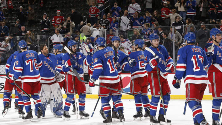 The New York Rangers react after defeating the New Jersey Devils