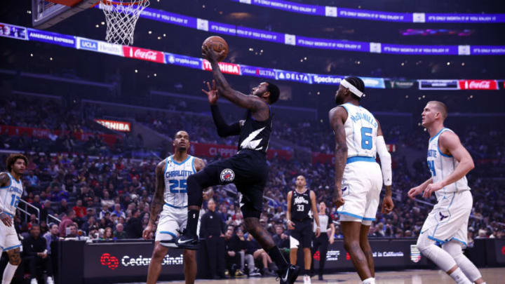 LOS ANGELES, CALIFORNIA - DECEMBER 21: John Wall #11 of the LA Clippers takes a shot against the Charlotte Hornets in the first half at Crypto.com Arena on December 21, 2022 in Los Angeles, California. NOTE TO USER: User expressly acknowledges and agrees that, by downloading and/or using this photograph, user is consenting to the terms and conditions of the Getty Images License Agreement. (Photo by Ronald Martinez/Getty Images)