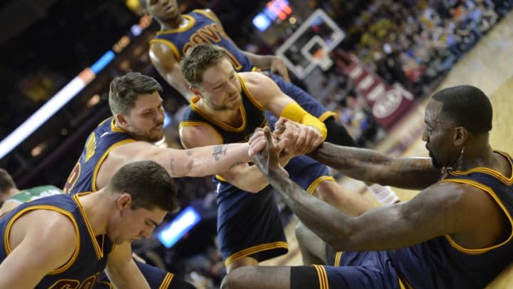 Mar 3, 2015; Cleveland, OH, USA; Cleveland Cavaliers center Kendrick Perkins (right) is helped to his feet by guard Joe Harris (from left), guard Mike Miller and guard Matthew Dellavedova in the fourth quarter against the Boston Celtics at Quicken Loans Arena. Mandatory Credit: David Richard-USA TODAY Sports