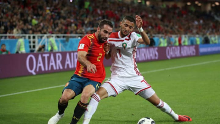KALININGRAD, RUSSIA – JUNE 25: Dani Carvajal of Spain battles for possession with Hakim Ziyach of Morocco during the 2018 FIFA World Cup Russia group B match between Spain and Morocco at Kaliningrad Stadium on June 25, 2018 in Kaliningrad, Russia. (Photo by Julian Finney/Getty Images)