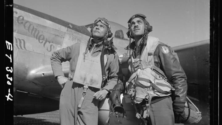 Col. Benjamin O. Davis (left), commanding officer of the 332nd Fighter Group, and Edward C. Gleed, group operations officer, stand in front of a plane in Ramitelli, Italy, in March 1945.