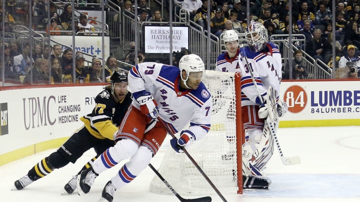 Feb 26, 2022; Pittsburgh, Pennsylvania, USA; New York Rangers defenseman K’Andre Miller (79) skates with the puck from behind the net as Pittsburgh Penguins center Jeff Carter (77) chases during the third period at PPG Paints Arena. The Penguins shutout the Rangers 1-0. Mandatory Credit: Charles LeClaire-USA TODAY Sports