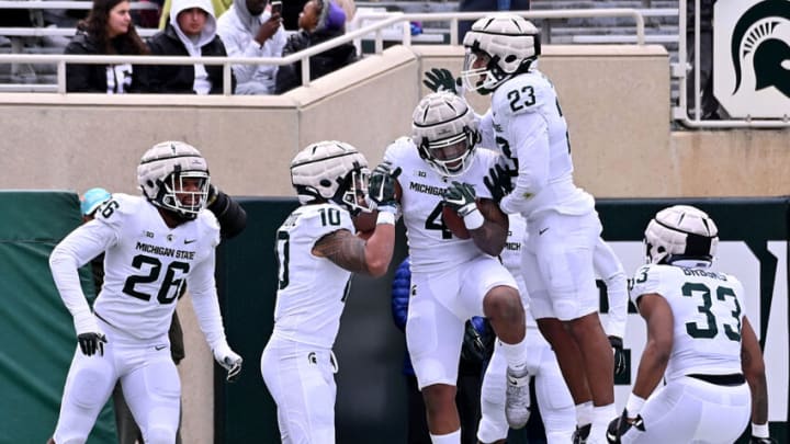 Apr 16, 2022; East Lansing, Michigan, USA; Michigan State University Spartans linebacker Jacoby Windmon (4) celebrates a fumble recovery for a touchdown with his defensive teammates at Spartan Stadium. Mandatory Credit: Dale Young-USA TODAY Sports