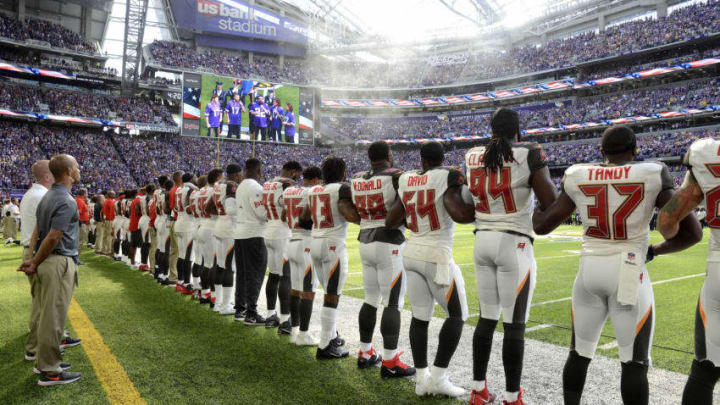 MINNEAPOLIS, MN - SEPTEMBER 24: Tampa Bay Buccaneers players link arms on the sidelines during the national anthem before the game against the Minnesota Vikings on September 24, 2017 at U.S. Bank Stadium in Minneapolis, Minnesota. (Photo by Hannah Foslien/Getty Images)