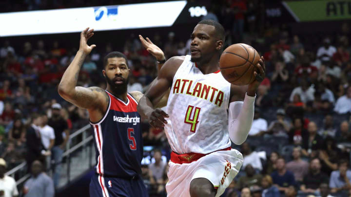 Apr 28, 2017; Atlanta, GA, USA; Atlanta Hawks forward Paul Millsap (4) passes away from the defense of Washington Wizards forward Markieff Morris (5) in the third quarter of game six of the first round of the 2017 NBA Playoffs at Philips Arena. Mandatory Credit: Jason Getz-USA TODAY Sports