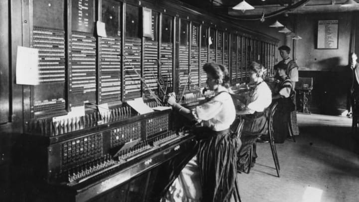 Operators at the switchboard of the Magneto Exchange of the National Telephone Company.