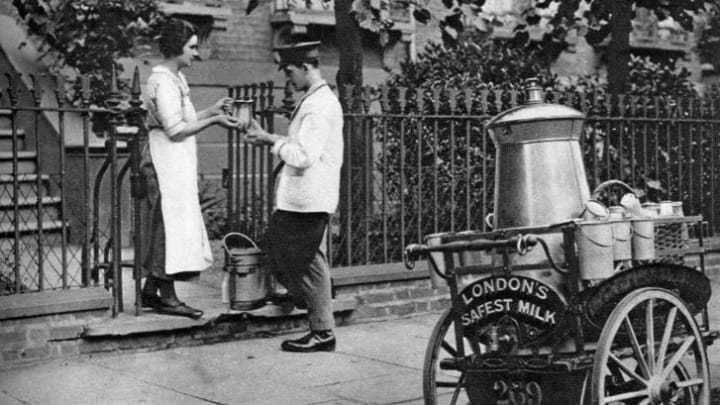 A milkman delivering milk to a North London resident, circa 1926-1927.