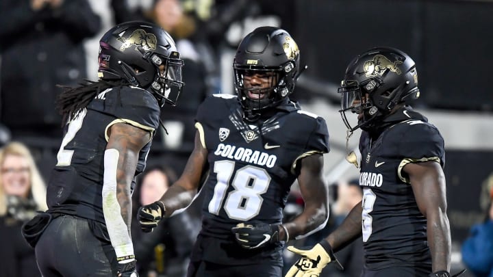 BOULDER, CO – OCTOBER 25: Laviska Shenault Jr. #2 of the Colorado Buffaloes is congratulated by Tony Brown #18 and K.D. Nixon #3 after scoring on a 73-yard touchdown catch against the USC Trojans in the third quarter of a game at Folsom Field on October 25, 2019 in Boulder, Colorado. (Photo by Dustin Bradford/Getty Images)