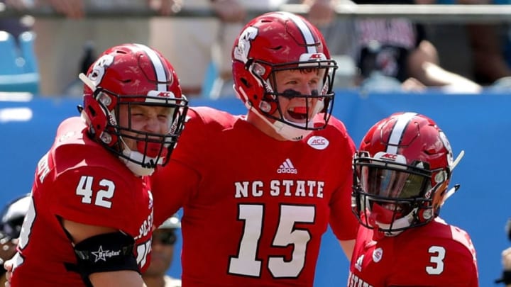 CHARLOTTE, NC - SEPTEMBER 02: Teammates Dylan Autenrieth #42, Ryan Finley #15 and Kelvin Harmon #3 of the North Carolina State Wolfpack react after a touchdown against the South Carolina Gamecocks during their game at Bank of America Stadium on September 2, 2017 in Charlotte, North Carolina. (Photo by Streeter Lecka/Getty Images)