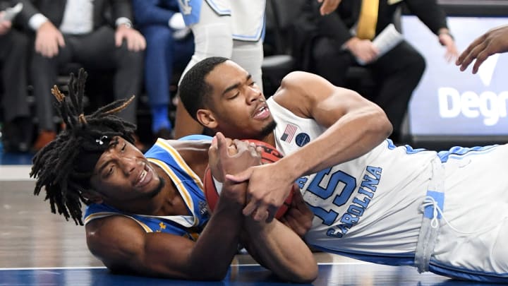 LAS VEGAS, NEVADA – DECEMBER 21: Jalen Hill #24 of the UCLA Bruins and Garrison Brooks #15 of the North Carolina Tar Heels scramble for the ball during the CBS Sports Classic at T-Mobile Arena on December 21, 2019 in Las Vegas, Nevada. The Tar Heels defeated the Bruins 74-64. (Photo by Ethan Miller/Getty Images)