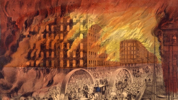 A Currier & Ives lithograph depicts people fleeing across the Randolph Street Bridge during the Great Chicago Fire of 1871.