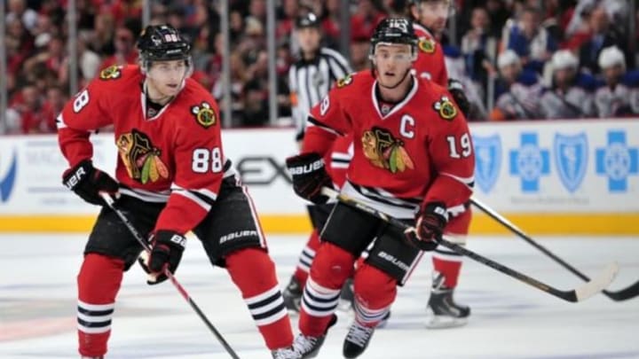 Jan 12, 2014; Chicago, IL, USA; Chicago Blackhawks right wing Patrick Kane (88) moves the puck with center Jonathan Toews (19) against the Edmonton Oilers during the second period at the United Center. Mandatory Credit: Rob Grabowski-USA TODAY Sports