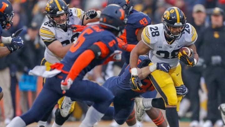CHAMPAIGN, IL - NOVEMBER 17: Toren Young #28 of the Iowa Hawkeyes runs the ball as Austin Roberts #36 of the Illinois Fighting Illini makes the tackle from behind at Memorial Stadium on November 17, 2018 in Champaign, Illinois. (Photo by Michael Hickey/Getty Images)