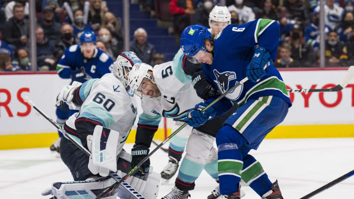 Feb 21, 2022; Vancouver, British Columbia, CAN; Seattle Kraken goalie Chris Driedger (60) makes a save as Vancouver Canucks forward Brock Boeser (6) battles for the rebound with defenseman Mark Giordano (5) in the third period at Rogers Arena. Canucks won 5-2. Mandatory Credit: Bob Frid-USA TODAY Sports