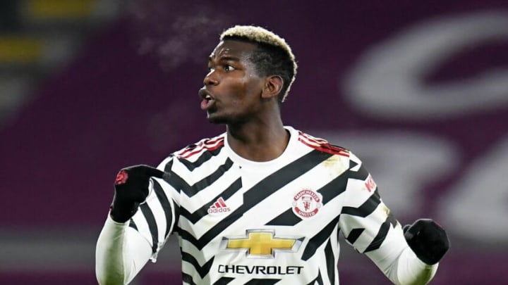 Manchester United's French midfielder Paul Pogba celebrates scoring the opening goal during the English Premier League football match between Burnley and Manchester United at Turf Moor in Burnley, north west England on January 12, 2021. (Photo by PETER POWELL / POOL / AFP) / RESTRICTED TO EDITORIAL USE. No use with unauthorized audio, video, data, fixture lists, club/league logos or 'live' services. Online in-match use limited to 120 images. An additional 40 images may be used in extra time. No video emulation. Social media in-match use limited to 120 images. An additional 40 images may be used in extra time. No use in betting publications, games or single club/league/player publications. / (Photo by PETER POWELL/POOL/AFP via Getty Images)
