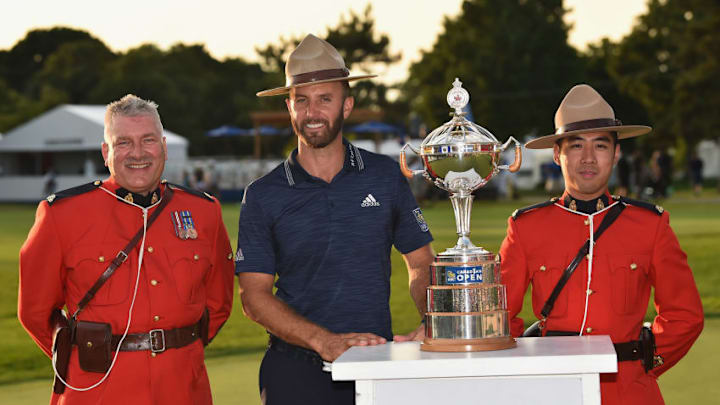 OAKVILLE, ON - JULY 29: Dustin Johnson poses with the trophy and Canadian Mounties during the final round at the RBC Canadian Open at Glen Abbey Golf Club on July 29, 2018 in Oakville, Canada. (Photo by Minas Panagiotakis/Getty Images)
