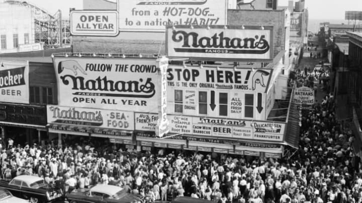 Crowds outside Nathan's famous hot dog stand, circa 1955.