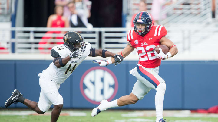 OXFORD, MS – OCTOBER 14: Running back Jordan Wilkins #22 of the Mississippi Rebels looks to run the ball by safety Ryan White #14 of the Vanderbilt Commodores at Vaught-Hemingway Stadium on October 14, 2017 in Oxford, Mississippi. (Photo by Michael Chang/Getty Images)