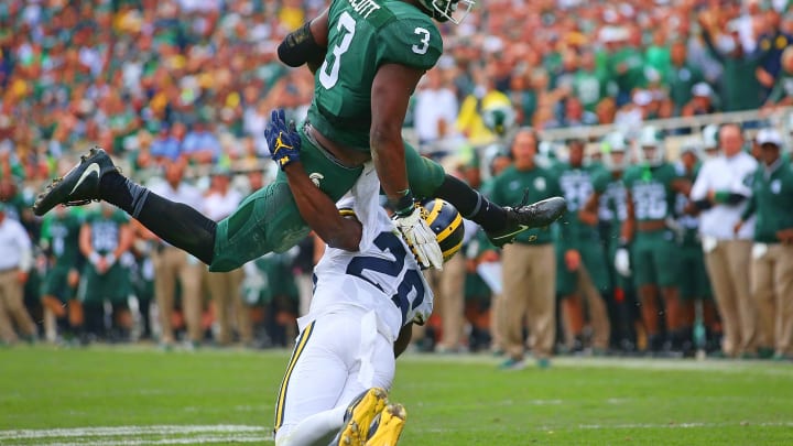 EAST LANSING, MI – OCTOBER 29: LJ Scott #3 of the Michigan State Spartans runs for a short gain as Jourdan Lewis #26 of the Michigan Wolverines makes the stop during the fourth quarter of the game at Spartan Stadium on October 29, 2016 in East Lansing, Michigan. Michigan defeated Michigan State 32-23. (Photo by Leon Halip/Getty Images)